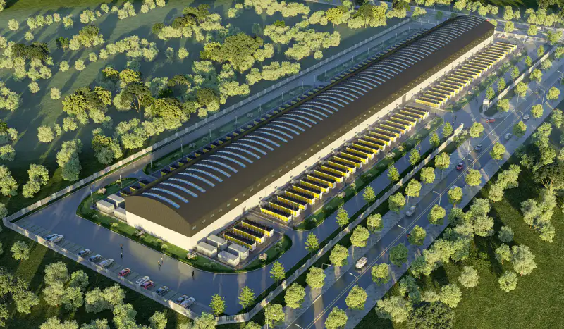 Aerial view of a hall-based deployment: a long warehouse roofed with solar arrays, flanked by two rows of outdoor heat-rejection modules.